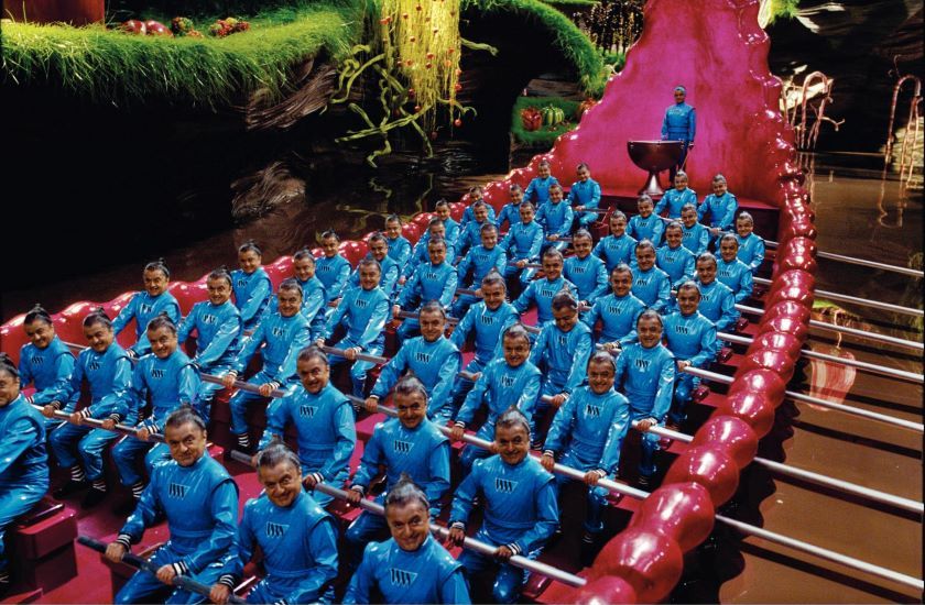Charlie and the Chocolate Factory Picture 11 Full shot of Oompa-Loompas Deep Roy) seated in rowboat.